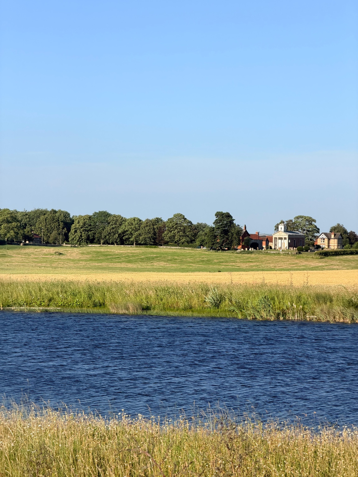 Reservoir, summer meadows and St Helen’s Church